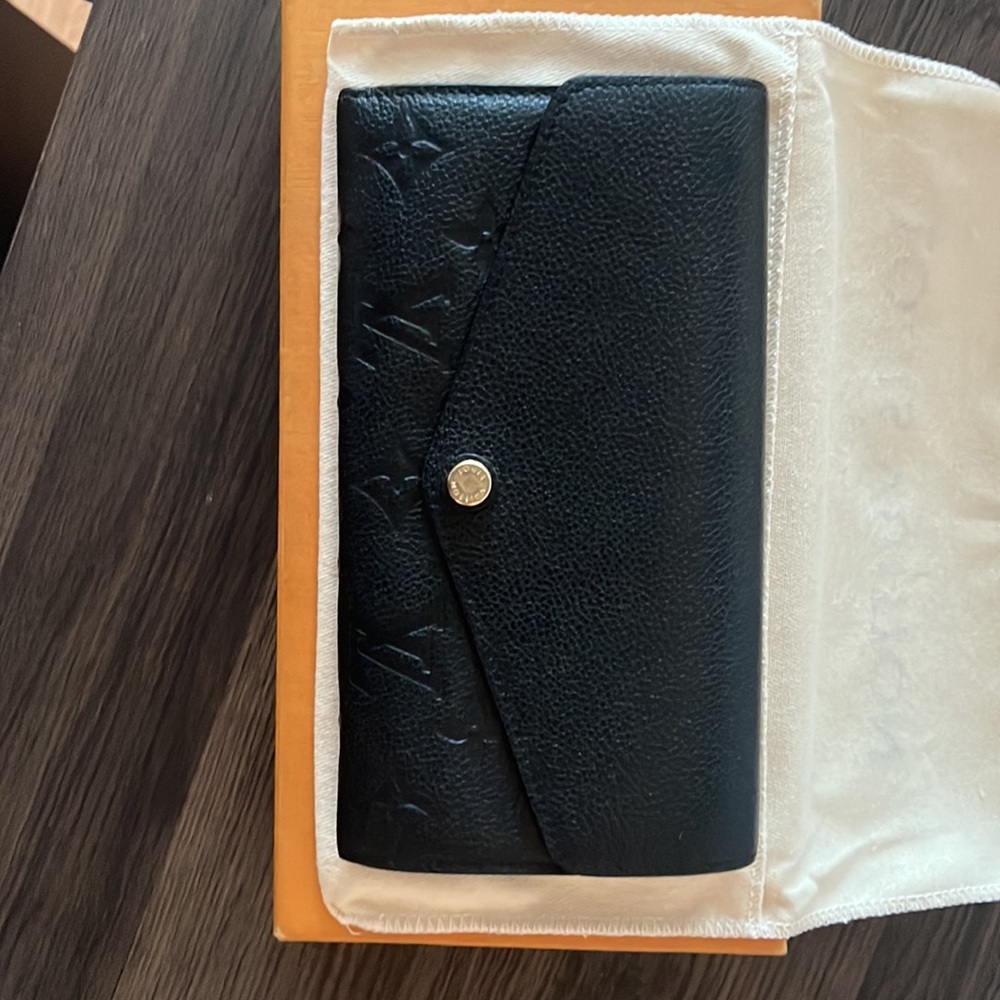 Black Sarah M Louis Vuitton women’s wallet.